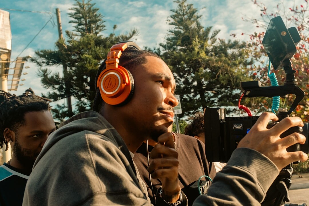 Two people recording a podcast conversation with microphones and headphones